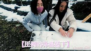 A white cat and a snow sculpture in an onsen (hot spring) bath