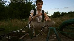 Young gay couple enjoys outdoor sex while cycling in summer