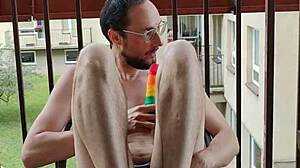 Public balcony fun with a rainbow dildo
